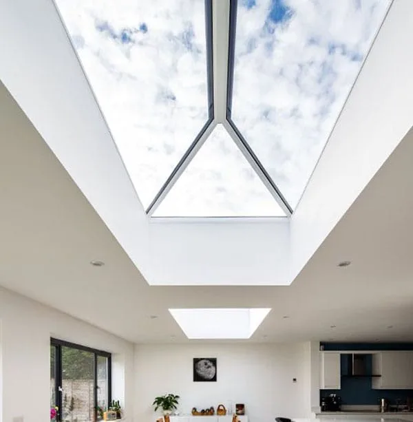 Pitched rooflight and flat rooflight bringing daylight into a modern open-plan home