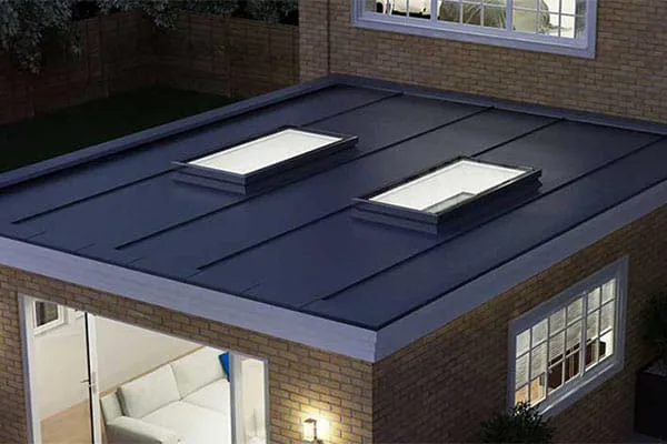 Flat roof with two rooflights on upstands at dusk