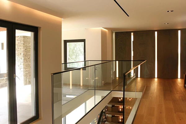 Frameless glass balustrade on a modern mezzanine floor with slim base channel