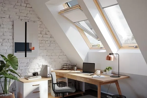 Bright attic home office lit by two pitched roof windows