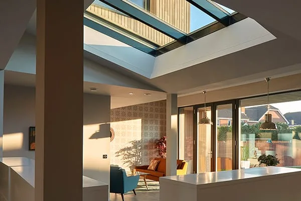 Large flat rooflight washing daylight deep into an open-plan living space