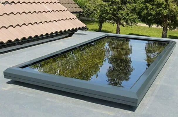Large flat rooflight with a slim grey frame on a flat roof