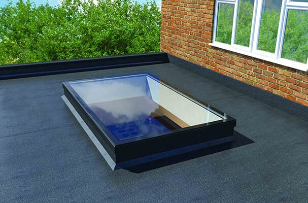 Flat rooflight with a black frame on a felt flat roof