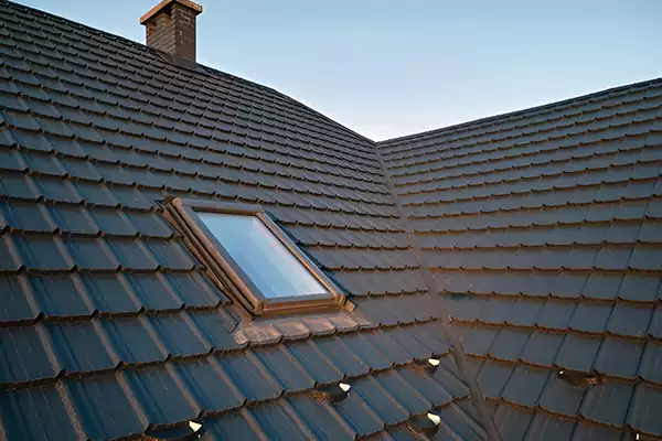 Centre-pivot pitched roof window set into a dark tiled roof