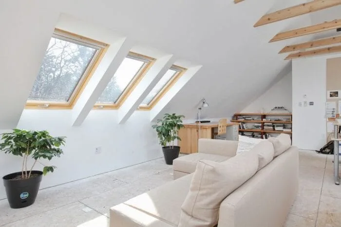 Spacious loft conversion living area illuminated by three pitched rooflights