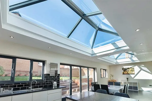 Large rooflight positioned directly over a kitchen island and dining space